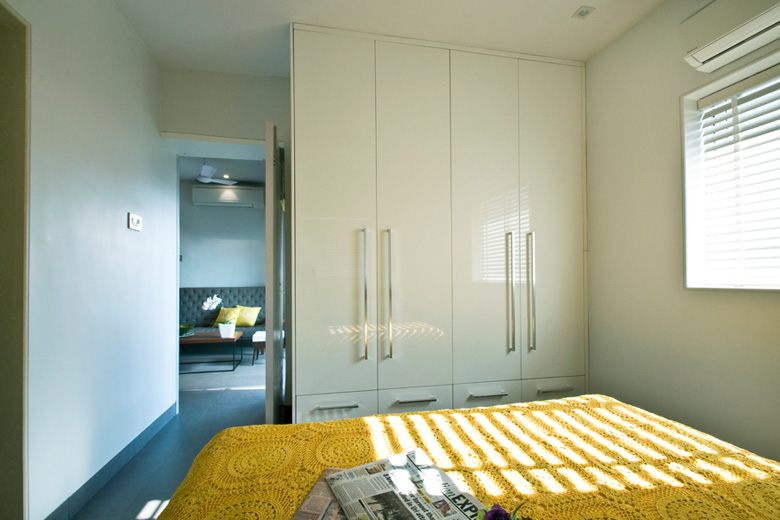 White bedroom with sunshine yellow bedsheet